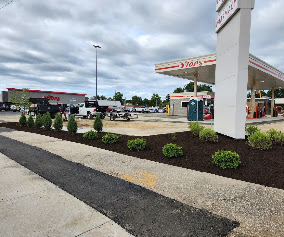 Retail gas station island plantings with fresh mulch and shrubs